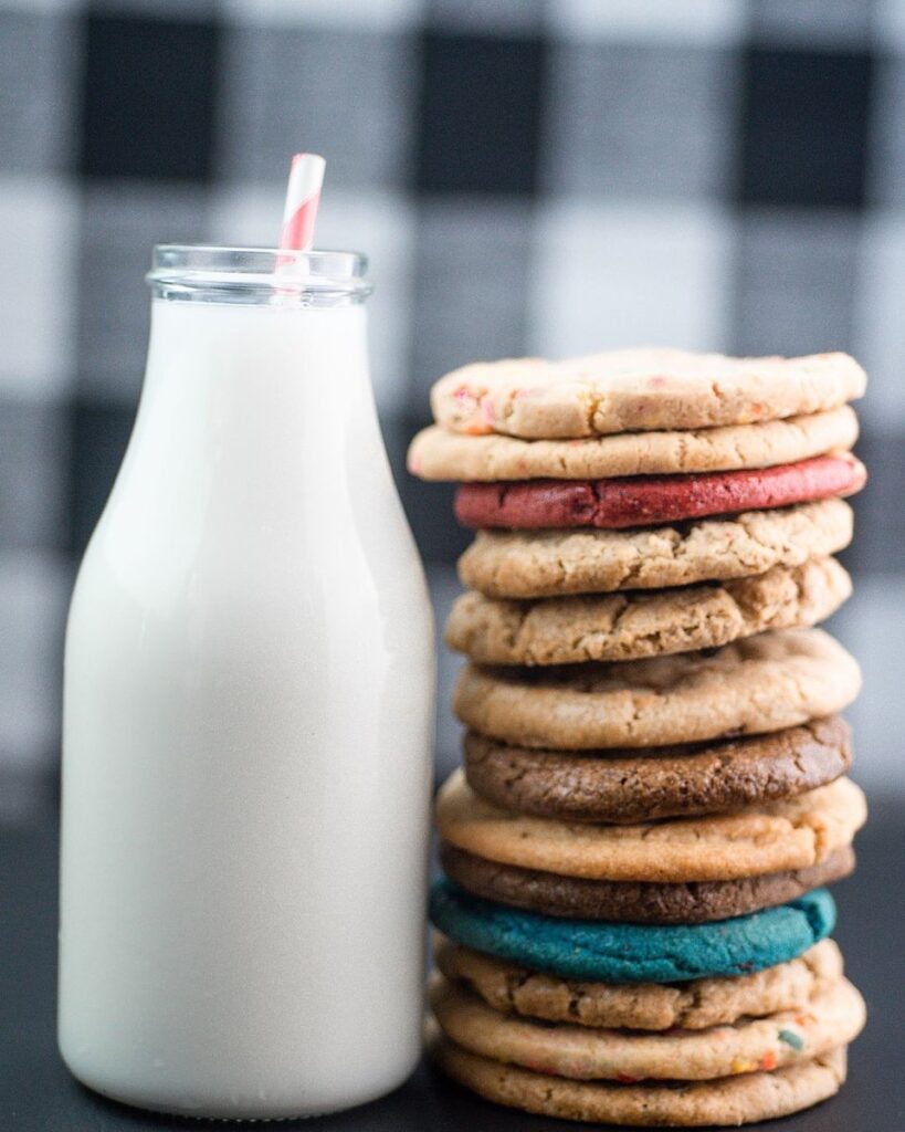A stack of Mama's Boy Cookies accompanied by a glass of milk.
