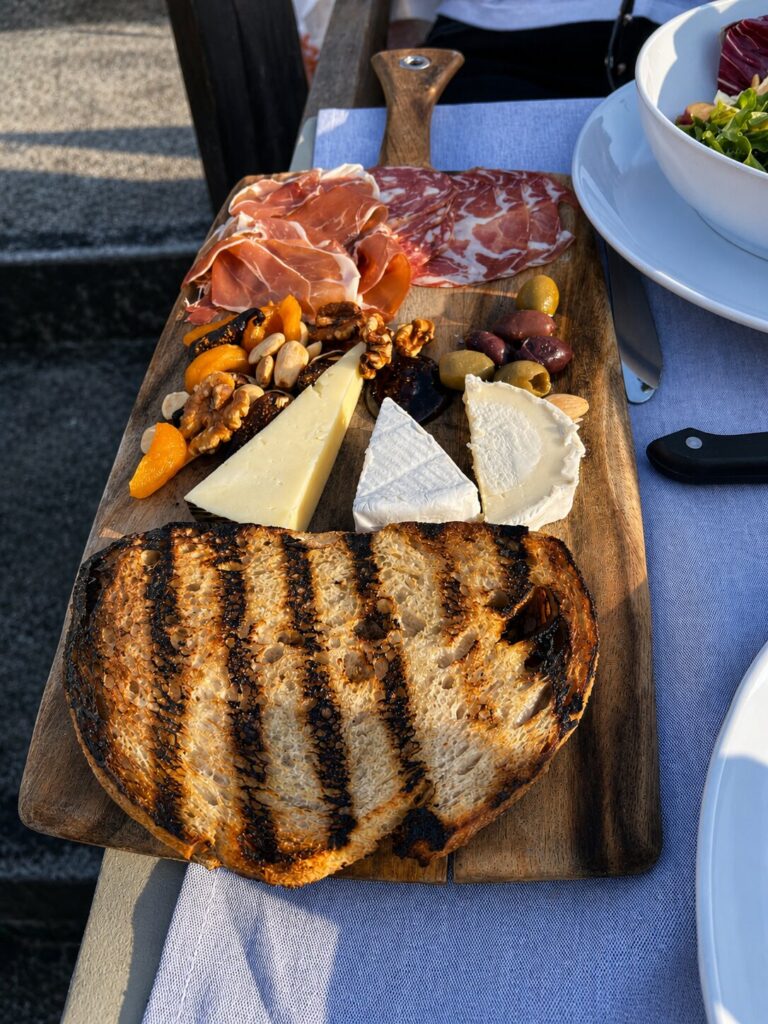 charcuterie and artisanal cheese course arrived with olives, dried fruit, and grilled sourdough